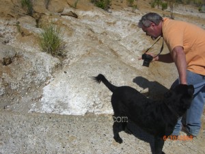 Serafine, and his dog Boo, inspect the white precipitate cascading down the hill June 10.