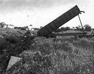 Photo circa 1971 shows rubble and what appear to be tombstones in the same location in the dump as the recently discovered tombstones.