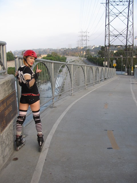 Derby prepares to go down a steep bridge next to the Los Angeles River.